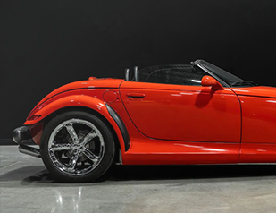 A red Plymouth Prowler in a showroom.